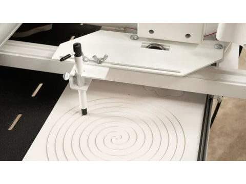 A stylus adapter plate and holder set with a stylus tracing a spiral pattern.
