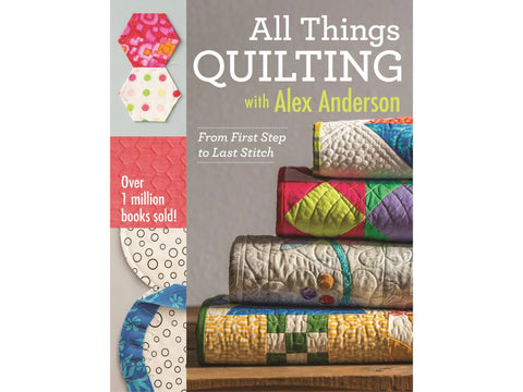 All Things Quilting book with fabric hexagons and stacked quilted items.