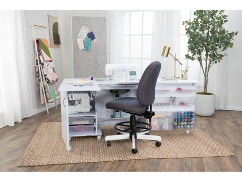 Koala All-In One Embroidery Studio in a craft room with a sewing machine and supplies.