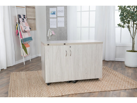 Koala All-In One Embroidery Studio in a light wood finish with two doors and wheels.
