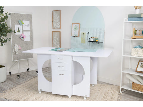 A white Koala cutting table with three drawers and two open shelves on wheels.