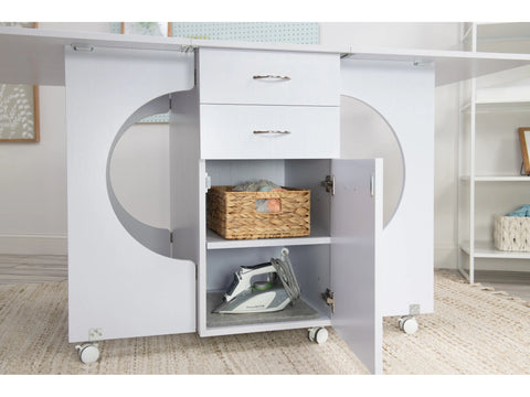 White Koala Cutting Table with two drawers, an open cabinet, and wheels.