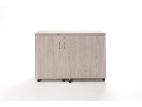 Light wood grain sewing cabinet with two doors, handles, and wheels.