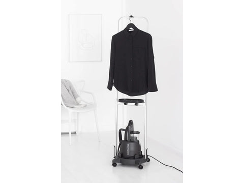 A black Laurastar steam cart with a black shirt hanging on it.