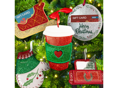 Six glittery Christmas ornament gift card holders hang on a Christmas tree.