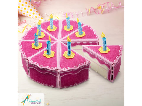 A pink fabric cake box with eight slices, one removed, and blue and yellow candles.