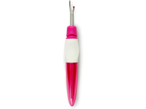 A pink and white ergonomic seam ripper with a red safety ball.