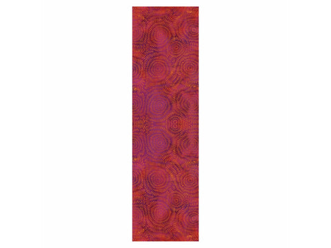 A long, rectangular piece of fabric with a pattern of concentric circles in shades of red, orange, and purple.