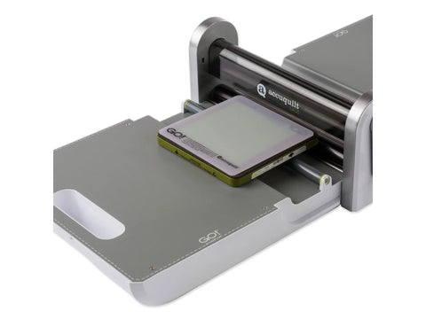 AccuQuilt GO! fabric cutter with a 6x6 inch cutting mat.