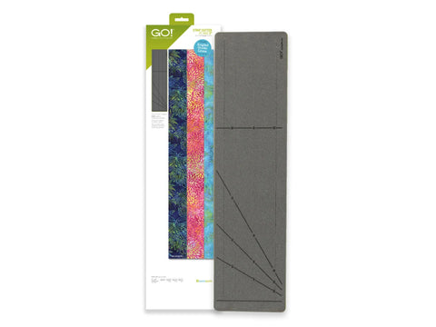 A fabric cutting die with angled guide lines and four colorful fabric strips.