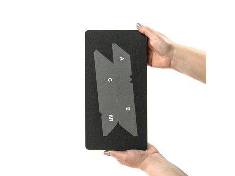 A person holds an AccuQuilt GO! Hunter Star Die with labeled cutting shapes.