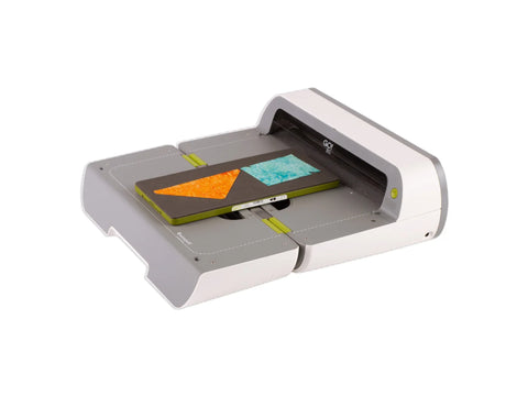 AccuQuilt GO! Big Electric Fabric Cutter Starter Set with fabric on a cutting mat.