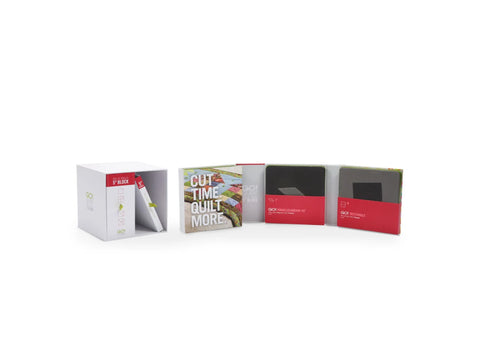A white box containing eight quilting dies, a cutting mat, and a pattern booklet.