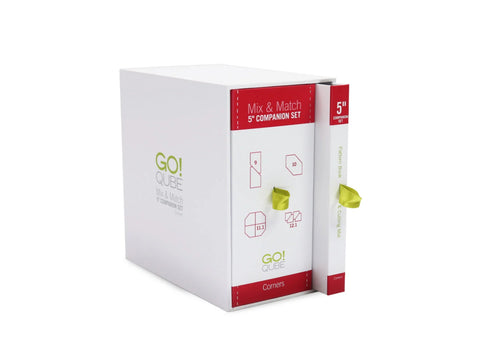White AccuQuilt Qube Companion Corners 5" box with a pattern book and cutting mat.