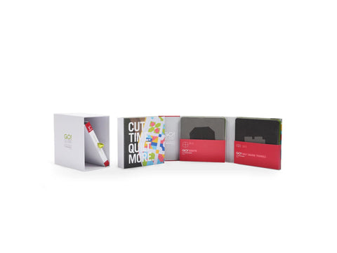 Four white boxes display AccuQuilt GO! Qube Companion Corners 5" dies and a pattern booklet.