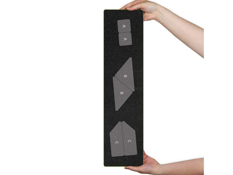 A person holds an AccuQuilt Arrowhead Die with three shapes labeled A, B, and C.