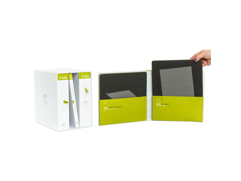 A white box containing several green and white fabric cutting dies, with one die being held.