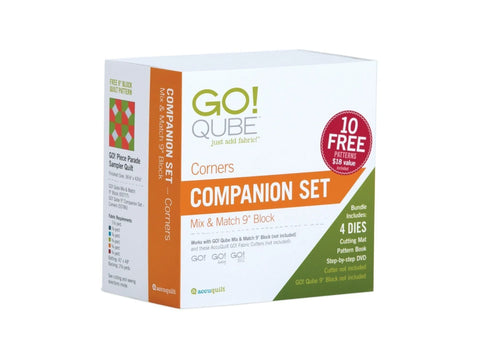A white box for the AccuQuilt Qube Companion Corners 9" set, featuring product details and a quilt pattern.