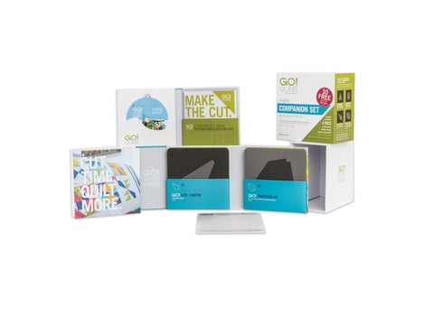 A collection of AccuQuilt Qube Companion Angles 6" quilting tools and instructional materials.