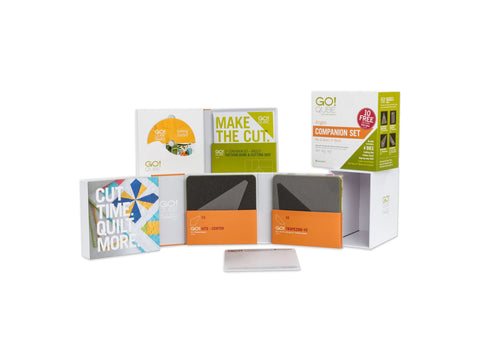 A collection of AccuQuilt GO! Qube Companion Angles 9" quilting tools and instructional materials.