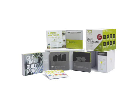 A collection of AccuQuilt Qube English Paper Piecing products, including dies, mats, and booklets.