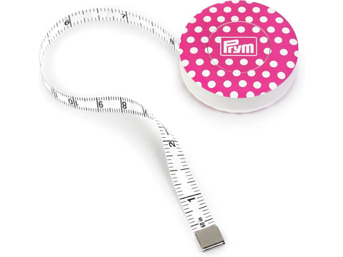 A white Prym Love magnetic tape measure with a pink polka dot case.