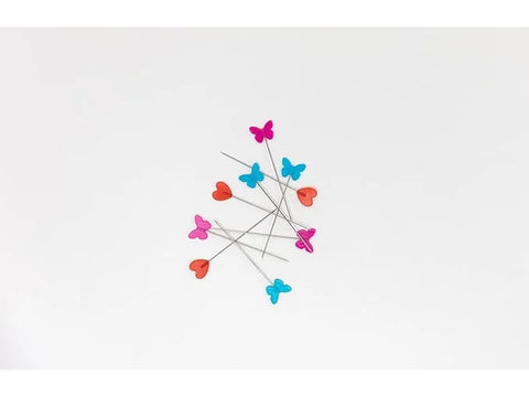 Fifty flat-head pins with red hearts, turquoise, and pink butterfly tops.