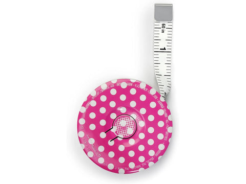 A pink polka dot Prym Love magnetic tape measure with 60 inches extended.