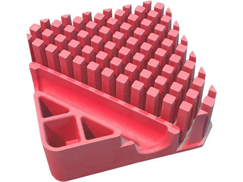 A flamingo pink organizer with numerous square compartments and a curved front section.