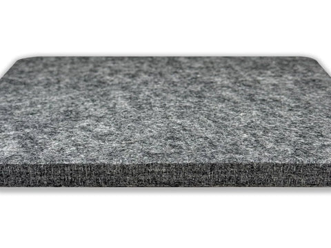 A gray, square wool pressing mat with rounded corners is shown from a low angle.