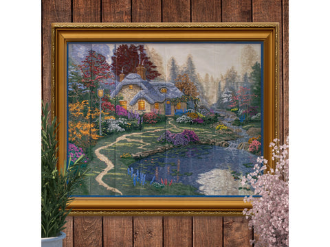 A framed tiling scene of Everett's Cottage by Thomas Kinkade, featuring a garden and pond.