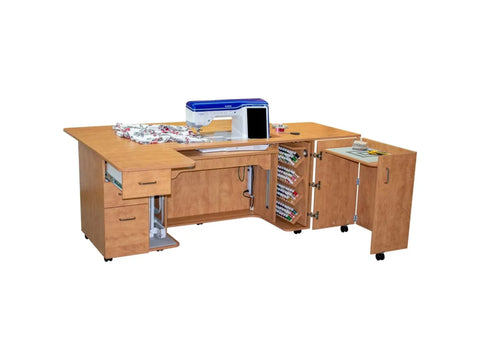 A light wood sewing cabinet with a sewing machine, fabric, and thread spools.