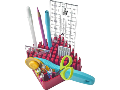 A red organizer holds various sewing and crafting tools.