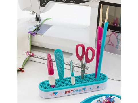 Prym Love Hold and Store Organizer with various sewing tools on a white table.