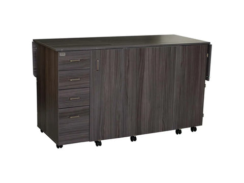 Dark wood sewing cabinet with four drawers and two folding side extensions on wheels.