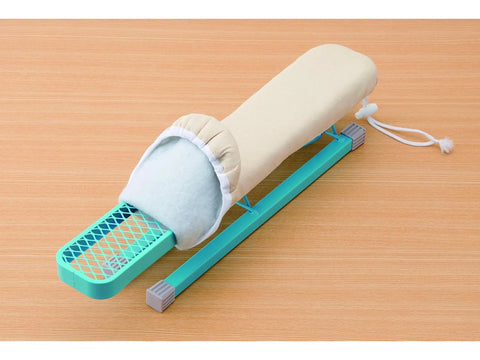 A beige replacement cover partially installed on a teal mini ironing board.