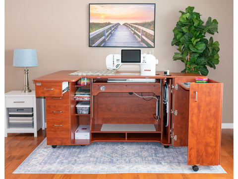 A tall, cherry-wood sewing cabinet with a sewing machine, open drawers, and storage compartments.