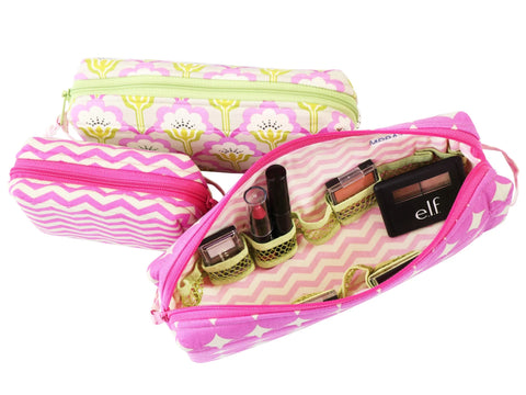 Three patterned cosmetic bags, one open to reveal makeup and elastic holders.