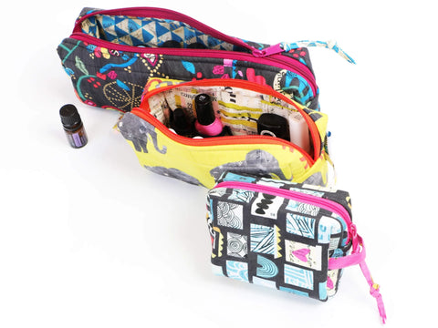 Three patterned fabric pouches, one large, one medium, and one small, are displayed open.