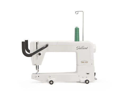 A white Baby Lock Gallant 15" long arm quilting machine with a spool of green thread.