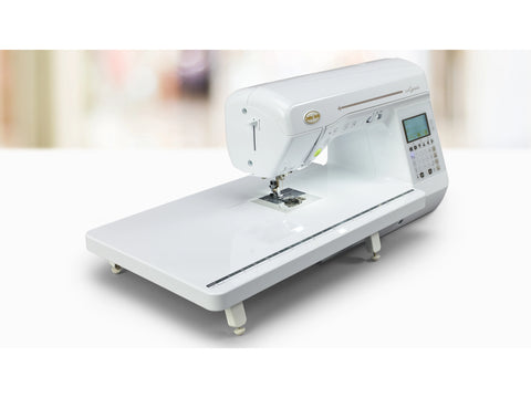 A white Baby Lock Lyric sewing and quilting machine with an extension table.