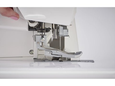 A close-up shows a hand adjusting the presser foot of a white serger machine.