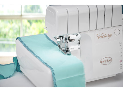 Baby Lock Victory serger with Jet-Air Threading System and light blue fabric.