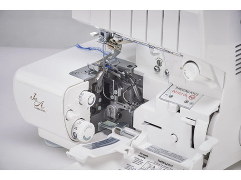 A white Baby Lock Victory serger with blue thread and open covers showing the threading system.