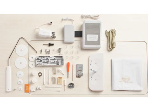 Baby Lock Chorus sewing and quilting machine accessories are neatly arranged on a light surface.