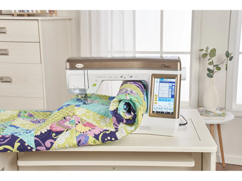 Baby Lock Chorus sewing and quilting machine with a colorful quilt.