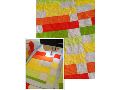 A colorful quilt with citrus-themed embroidery is shown, with a sewing machine working on a section.