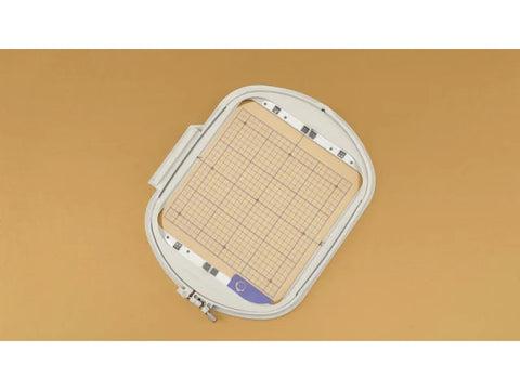 IQ Intuition Positioning Embroidery Hoop and Grid (9 1/2" X 9 1/2") on a tan background.