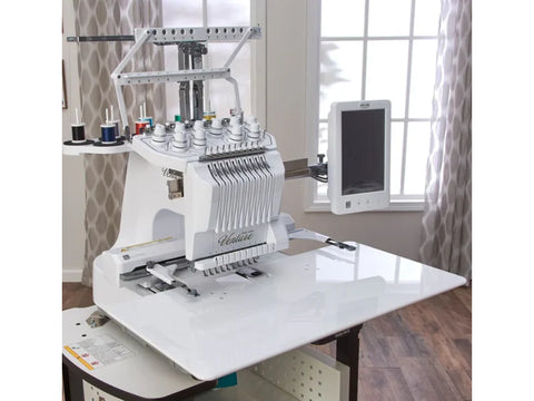 White Baby Lock embroidery machine with an extension table in a room with a window.