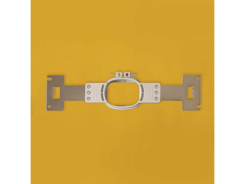 A silver multi-needle embroidery frame with a small oval hoop on a yellow background.